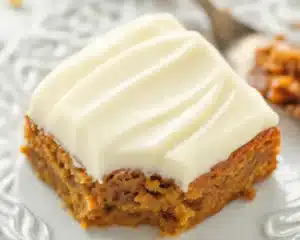 Delicious Hawaiian Carrot Pineapple Cake topped with cream cheese frosting and garnished with pineapple.