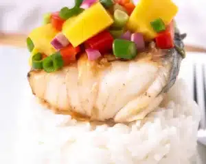 best recipe for wahoo fish 12 Delicious grilled wahoo fish with mango salsa and spices on a plate.