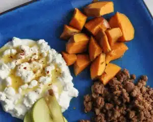 A colorful taco sweet potato bowl filled with roasted sweet potatoes, ground meat, and fresh toppings.