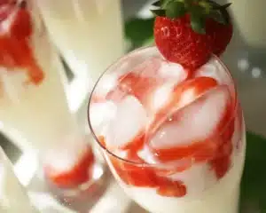 Strawberries and Cream Soda — Homemade Refreshing Summer Drink 6 A refreshing glass of strawberries and cream soda topped with whipped cream and fresh strawberries.