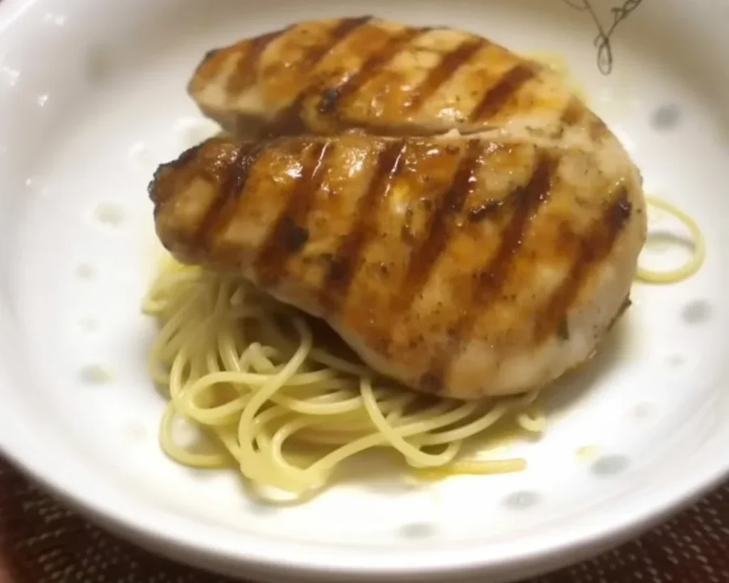 Seared wahoo fillets garnished with mango salsa and fresh herbs on a plate.