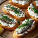 Sardine Goat Cheese Crostini served on a platter as an elegant appetizer.