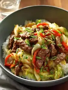 Skillet beef cabbage stir-fry served with colorful vegetables in a pan