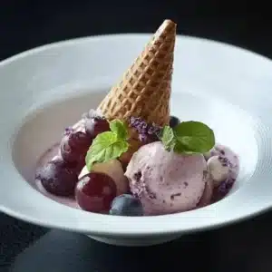 Delicious homemade grape ice cream in a bowl with fresh grapes