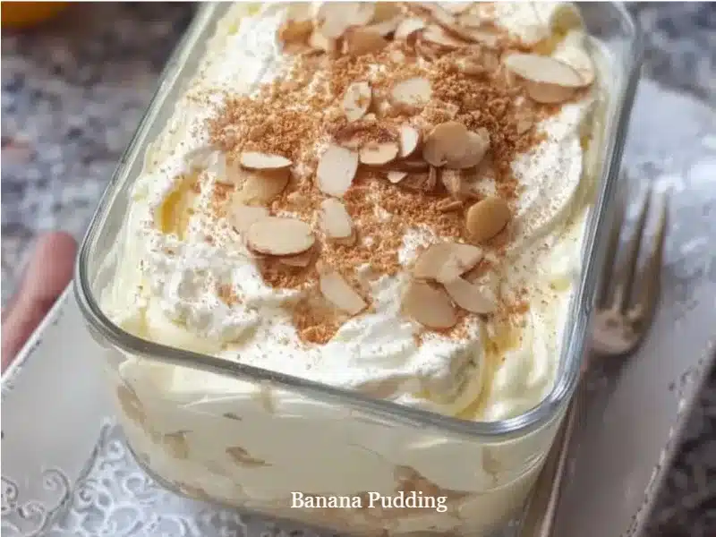 Homemade banana pudding showcasing layers of bananas, cream, and vanilla wafers.