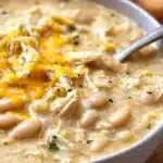 Bowl of quick and easy white chicken chili topped with cilantro and sour cream