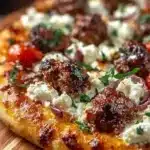 Sausage Feta Pizza topped with sausage, feta cheese, and fresh herbs