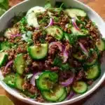 Spicy Korean Ground Beef served with Cucumber Salad on a plate