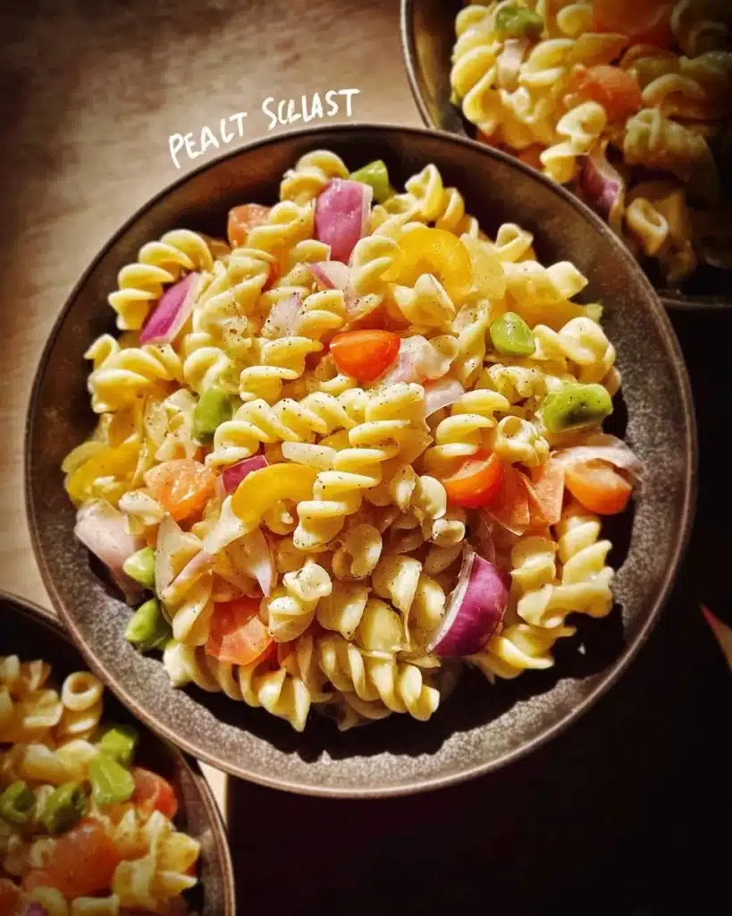 Delicious chilled pasta salad with colorful vegetables and dressing