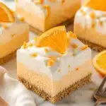 Delicious Creamsicle No-Bake Orange Bars on a white plate