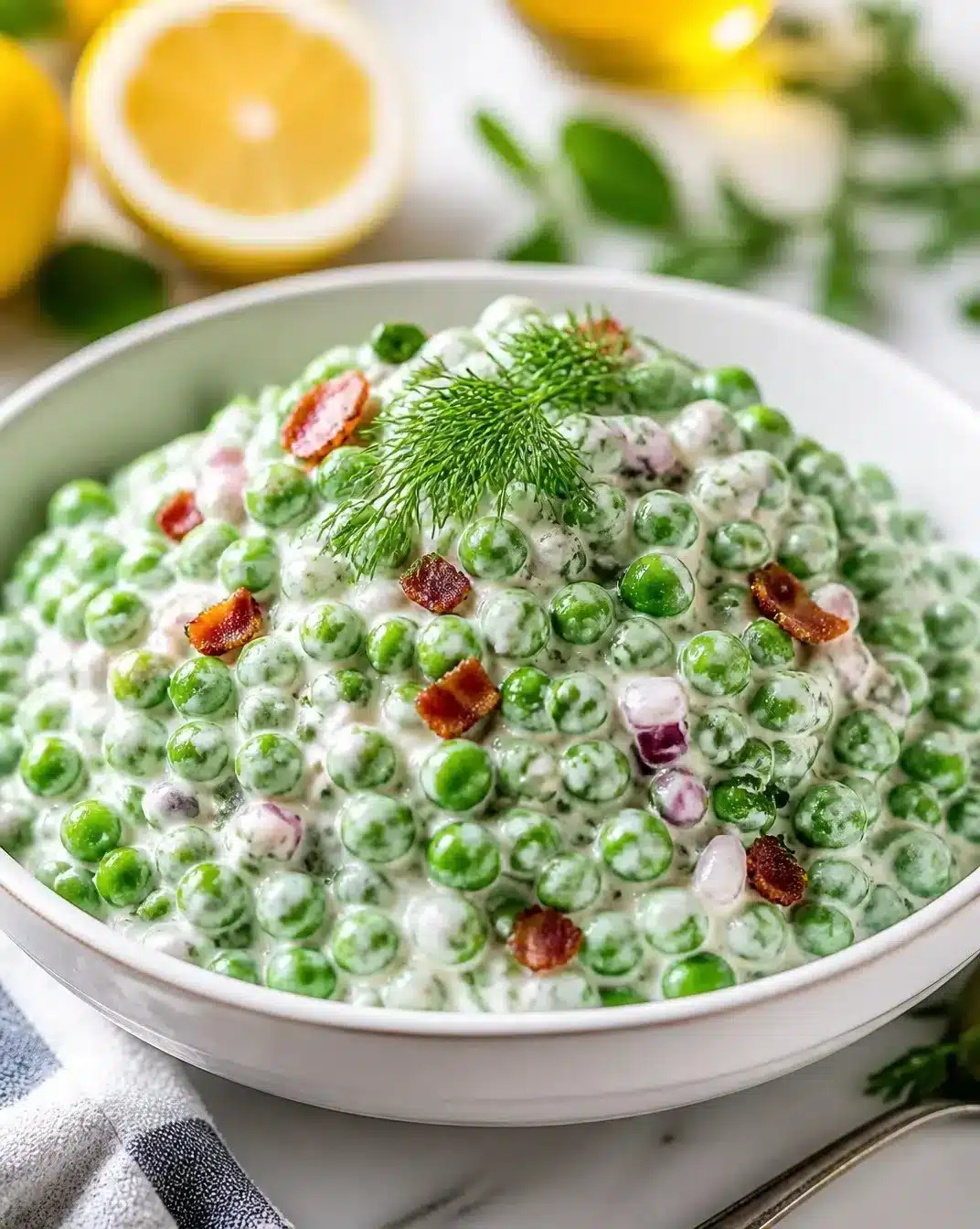 Creamy Greek Yogurt and English Pea Salad 1 Creamy Greek yogurt and English pea salad garnished with herbs