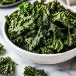 Bowl of crispy air fryer kale chips garnished with spices