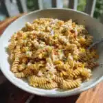 Crispy street corn pasta salad topped with cotija cheese and lime.