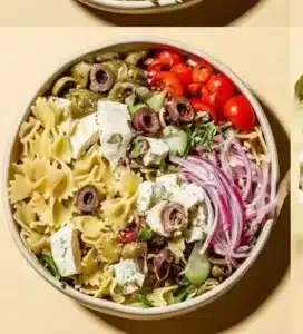 Crowd-Pleasing Pasta Salad 5 Delicious crowd-pleasing pasta salad served in a bowl with fresh vegetables.