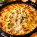 Delicious hot crab dip served in a bowl with bread for dipping