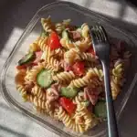 Protein-packed Italian pasta salad with colorful vegetables and dressing