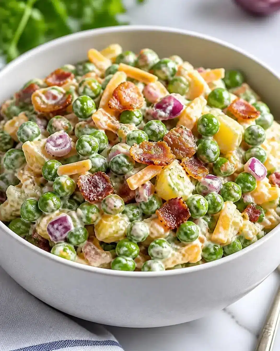 Traditional English Pea Salad 1 Bowl of Traditional English Pea Salad with fresh greens and vibrant peas